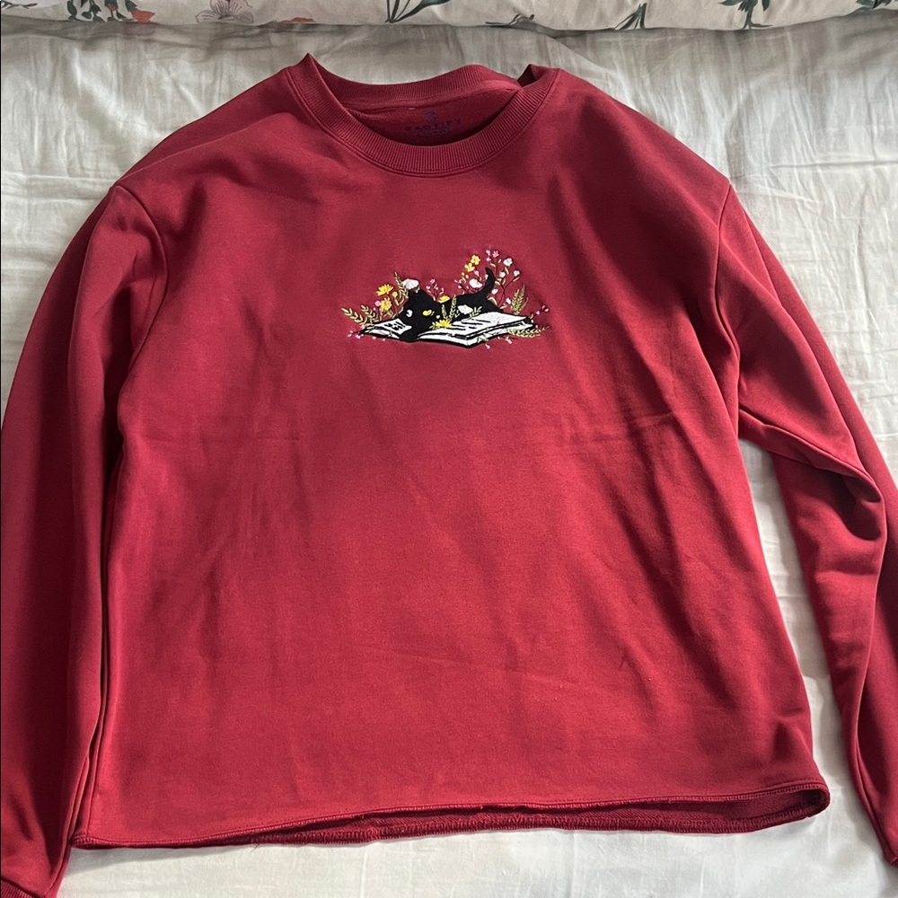 Red Sweatshirt with Embroidered Cat and Book Design